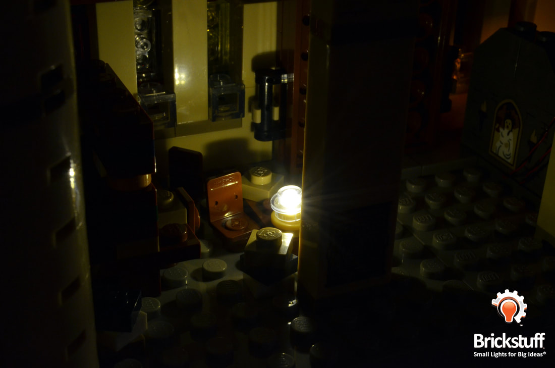 Photo of LEGO Hogwarts Castle common room at night with the Brickstuff light and sound kit installed.